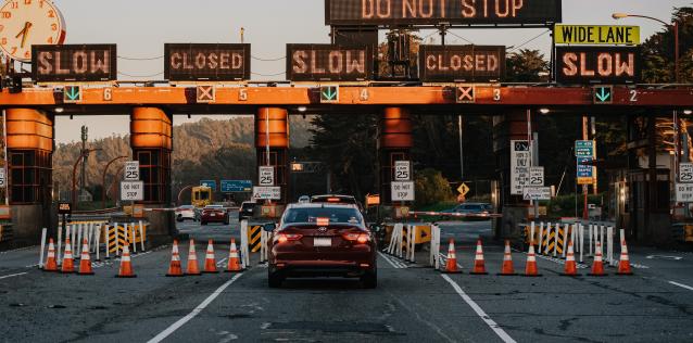 Cars at a border crossing checkpoint waiting in lanes to pass security