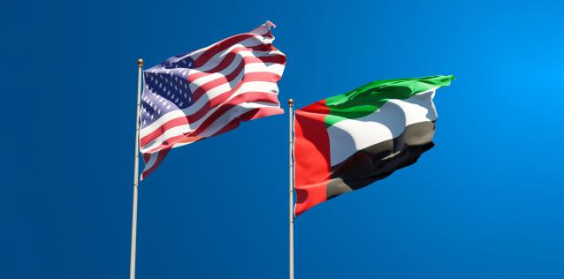 National state flags of USA and UAE United Arab Emirates together at the sky background.