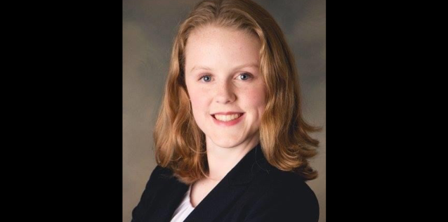 A picture of a woman with blonde hair in a suit