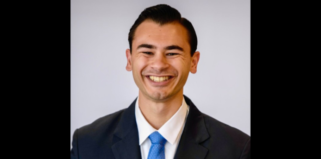 Man in blue tie and black suit