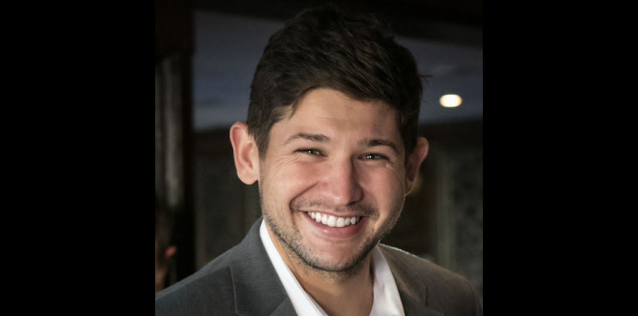 Man smiling wearing a white shirt and a suit