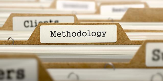 A close up on the tabs of a stack of file folders, focused on one central folder tab labeled "Methodology."