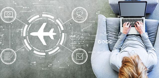 Man sitting in grey chair typing on a laptop. Overlaid with digital travel icons.