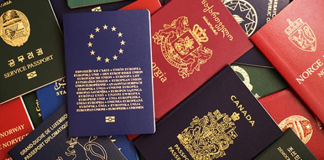 pile of passports from various countries