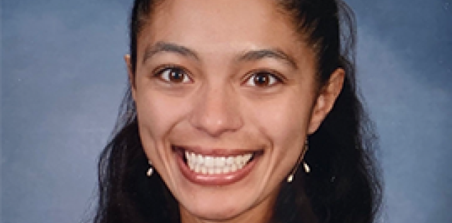 Headshot of a woman with long dark hair