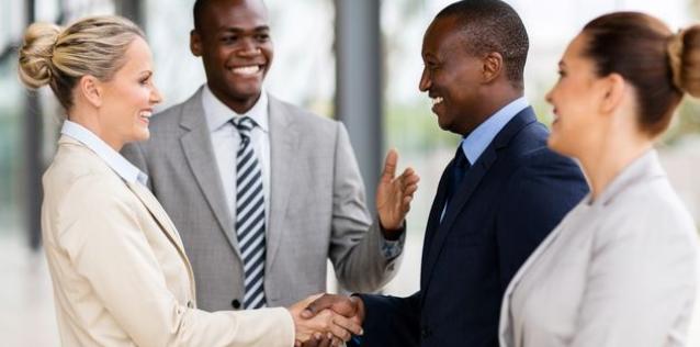 Group of people meeting and shaking hands.