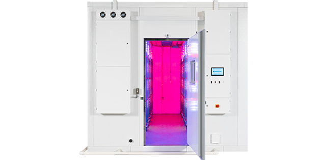 An environmental research chamber with a pink-interior glow