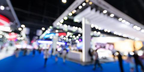Floor of a trade show showing booth and people with blurred effect