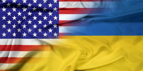 Image of U.S. flag fading into the Ukrainian flag