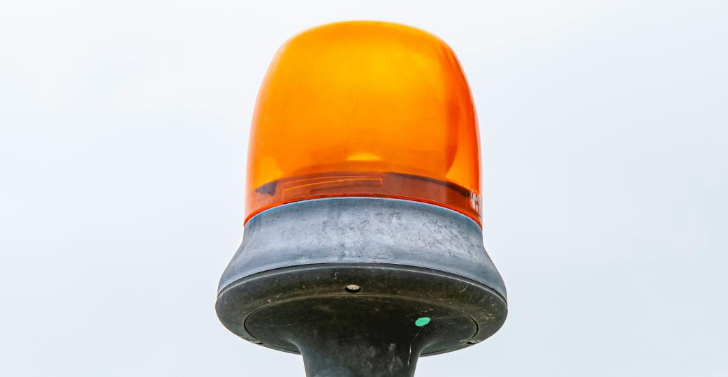 orange alert light on a grey background