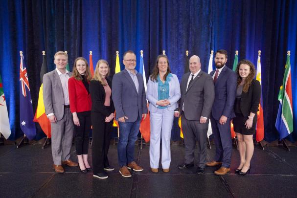 REC staff receive the NDTO's Export Service Provider of the Year Award at the 2022 Global Business Connections Conference in Fargo L-R: Kyle Berger, Kate Best, Cassie Bergman, Lt. Governor Brent Sanford, Heather Ranck, NDTO Director Drew Combs, Joshua Erickson, Haley Coffield