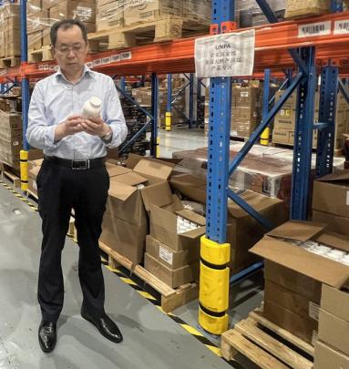 man in warehouse looking at U.S. supplement in China