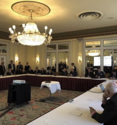 Ballroom conference room with lights turned on and meeting going on