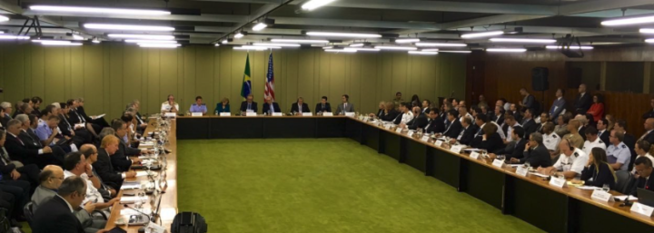 Large square table with many representatives and green carpet 