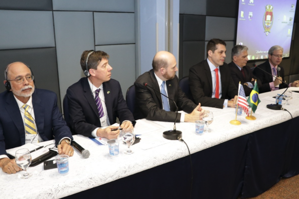 Four men sitting at a table representing different countries